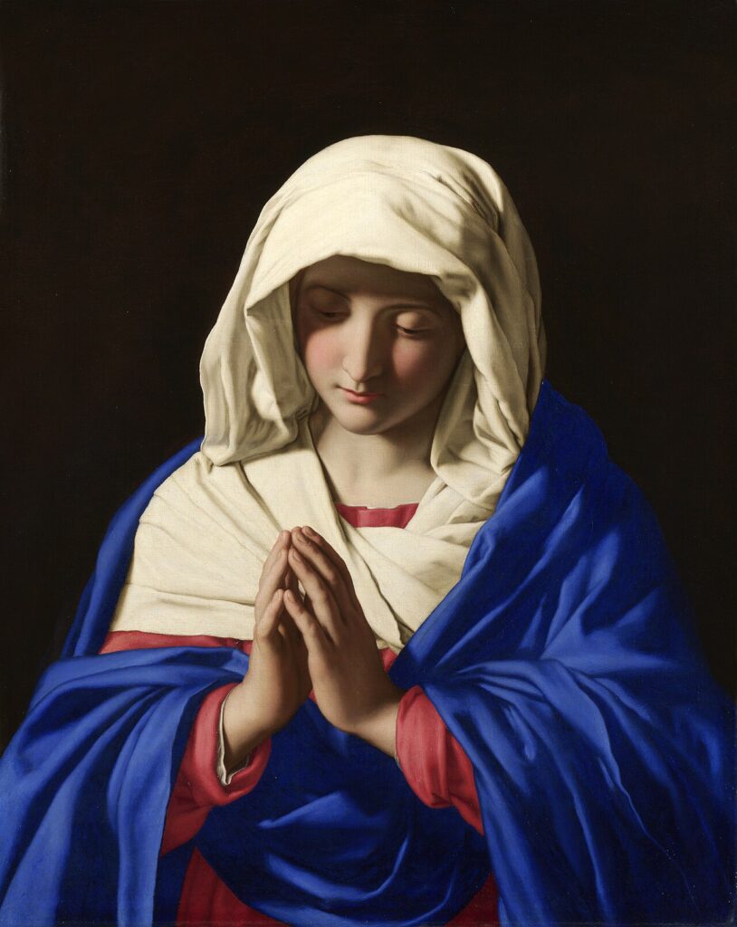 Baroque painting of the Virgin Mary in quiet prayer, head bowed beneath a blue mantle and white veil.