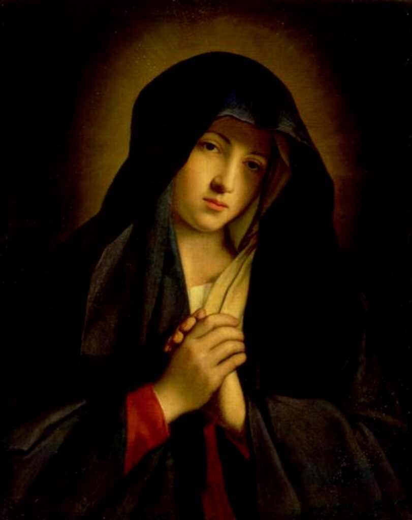 Sorrowful Virgin Mary with downcast eyes and hands clasped, wearing a deep blue mantle.