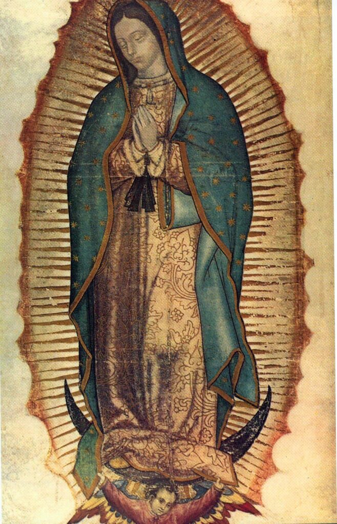 The Virgin of Guadalupe in a star-spangled blue-green mantle, hands joined in prayer, surrounded by golden rays.