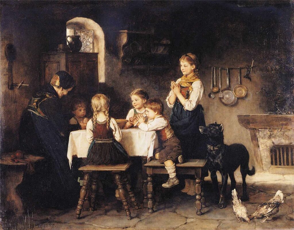 A family praying in thanks before a meal.