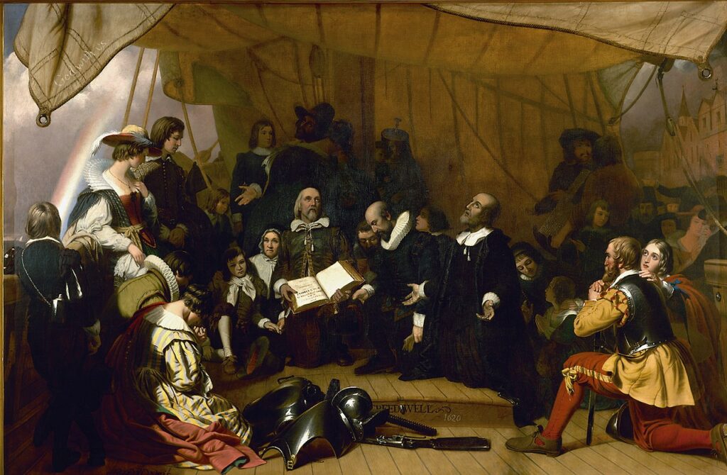 Pilgrims in a prayer of thanksgiving with an open Bible.